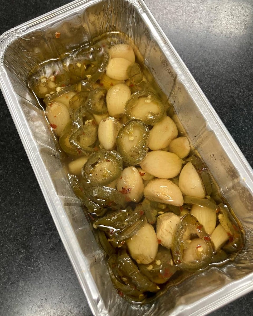 garlic cloves and pepper flakes on table