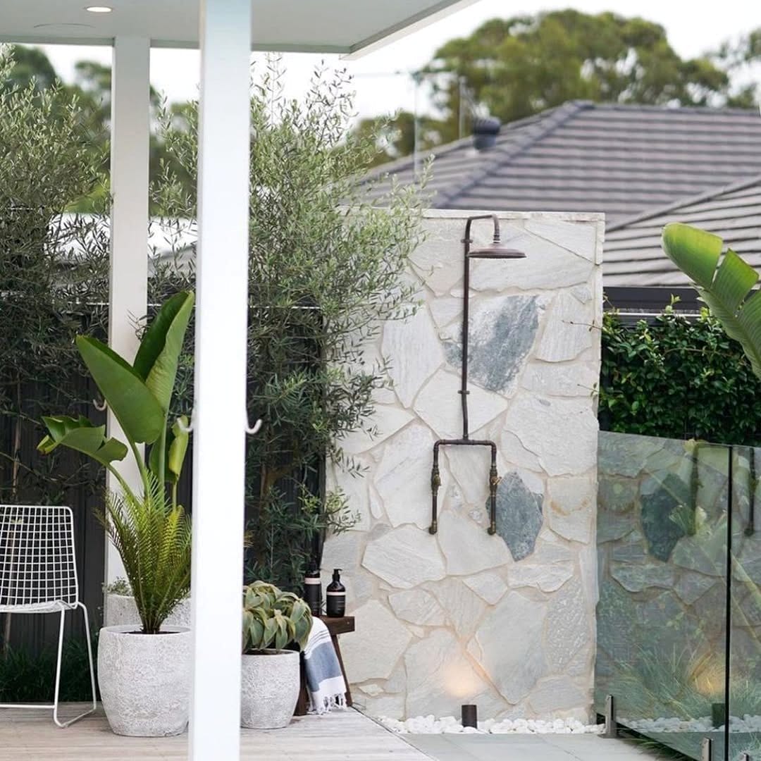 Outdoor shower floor with lava rocks