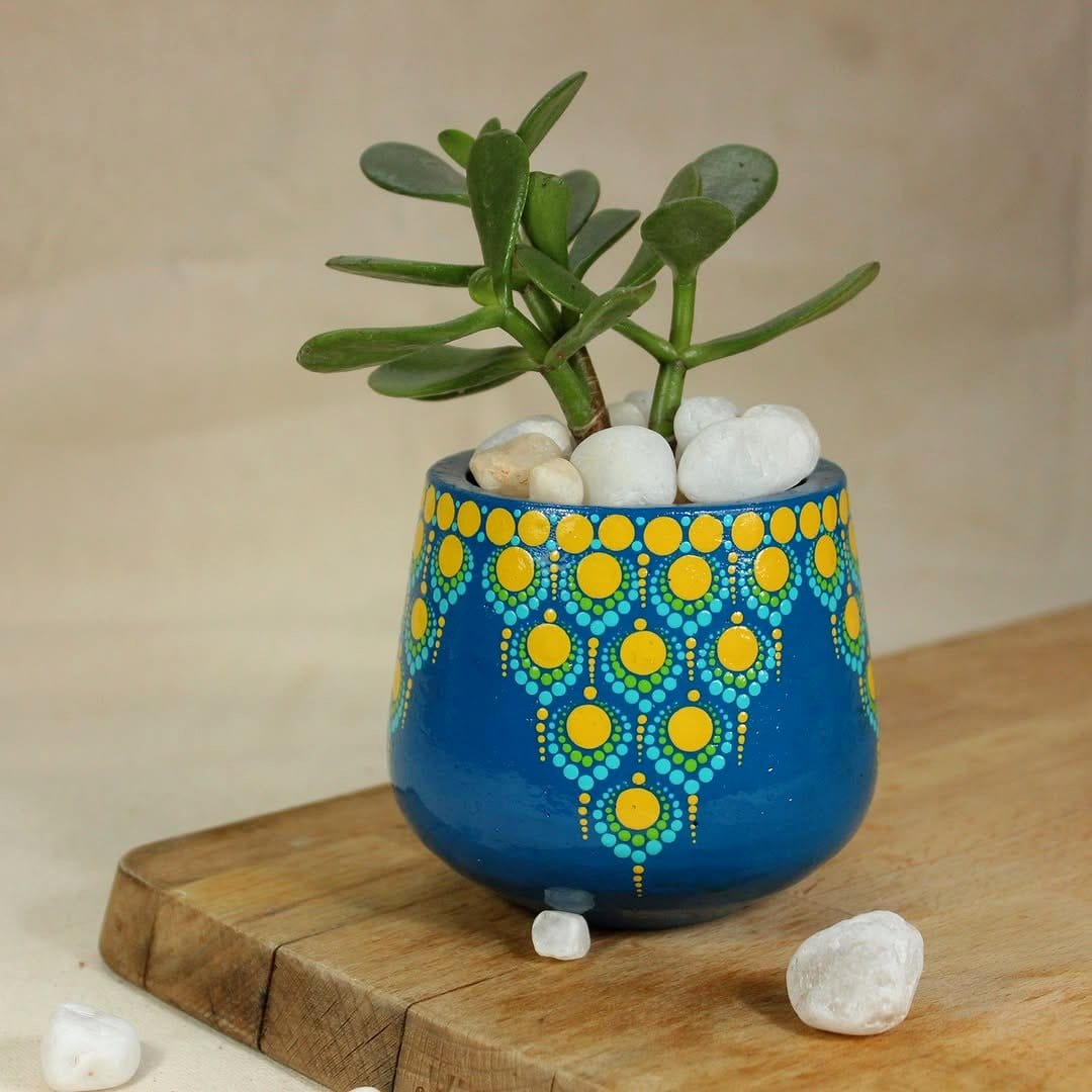 Colorful mandala design on a painted plant pot