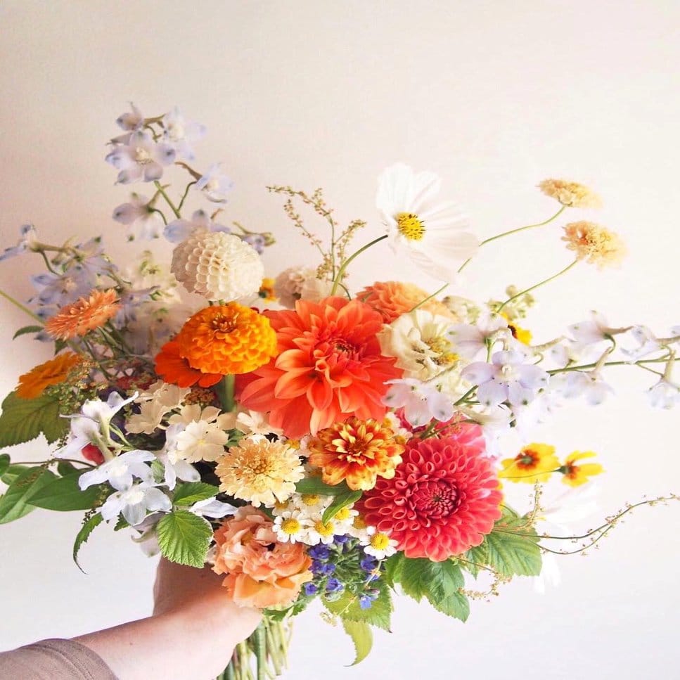 Floral arrangement with citrus and Mediterranean blooms
