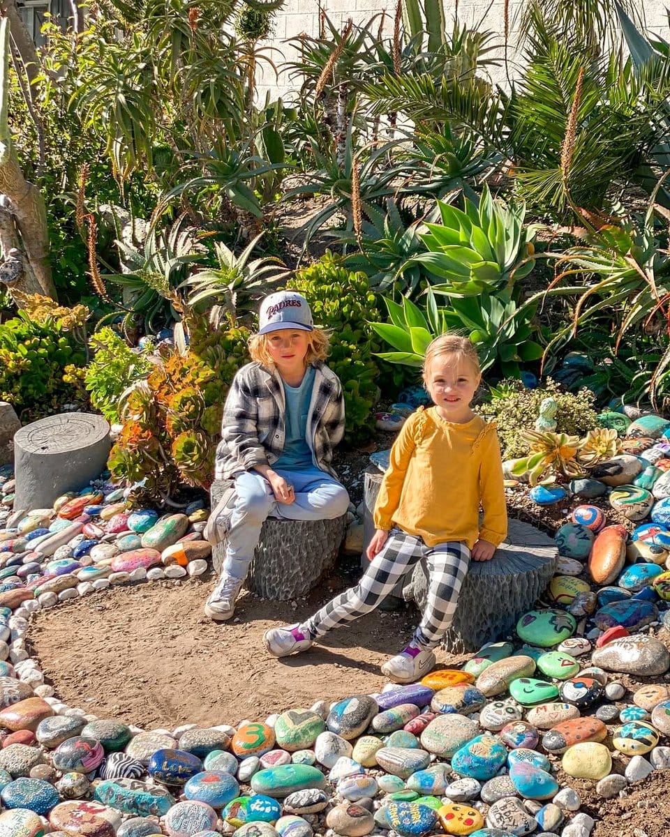 colorful painted rocks in a garden bed