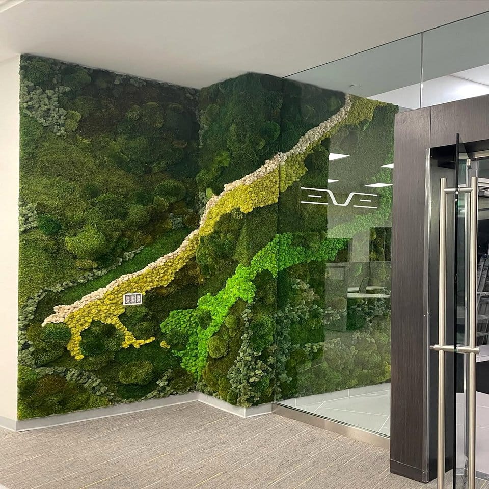 Lush green hanging vines and moss wall installation