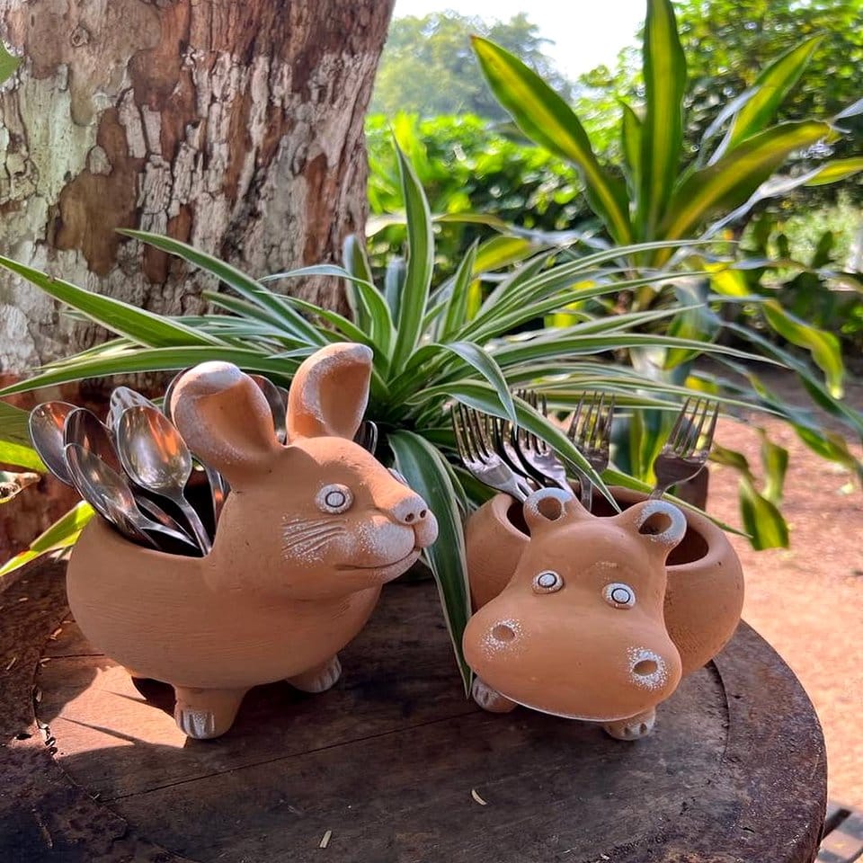 Hand-painted plant pot with whimsical animal motifs