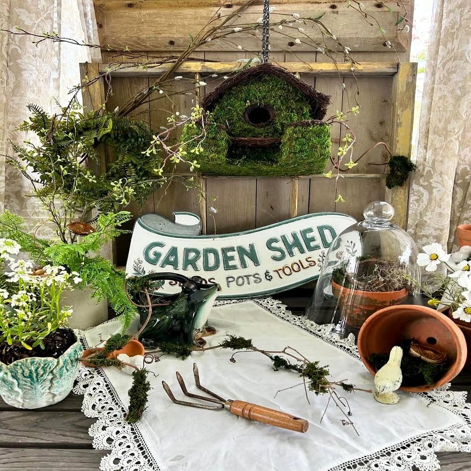 Rustic birdhouse nestled in moss