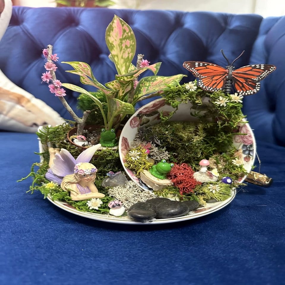 Vintage teacups filled with moss and mushroom accents