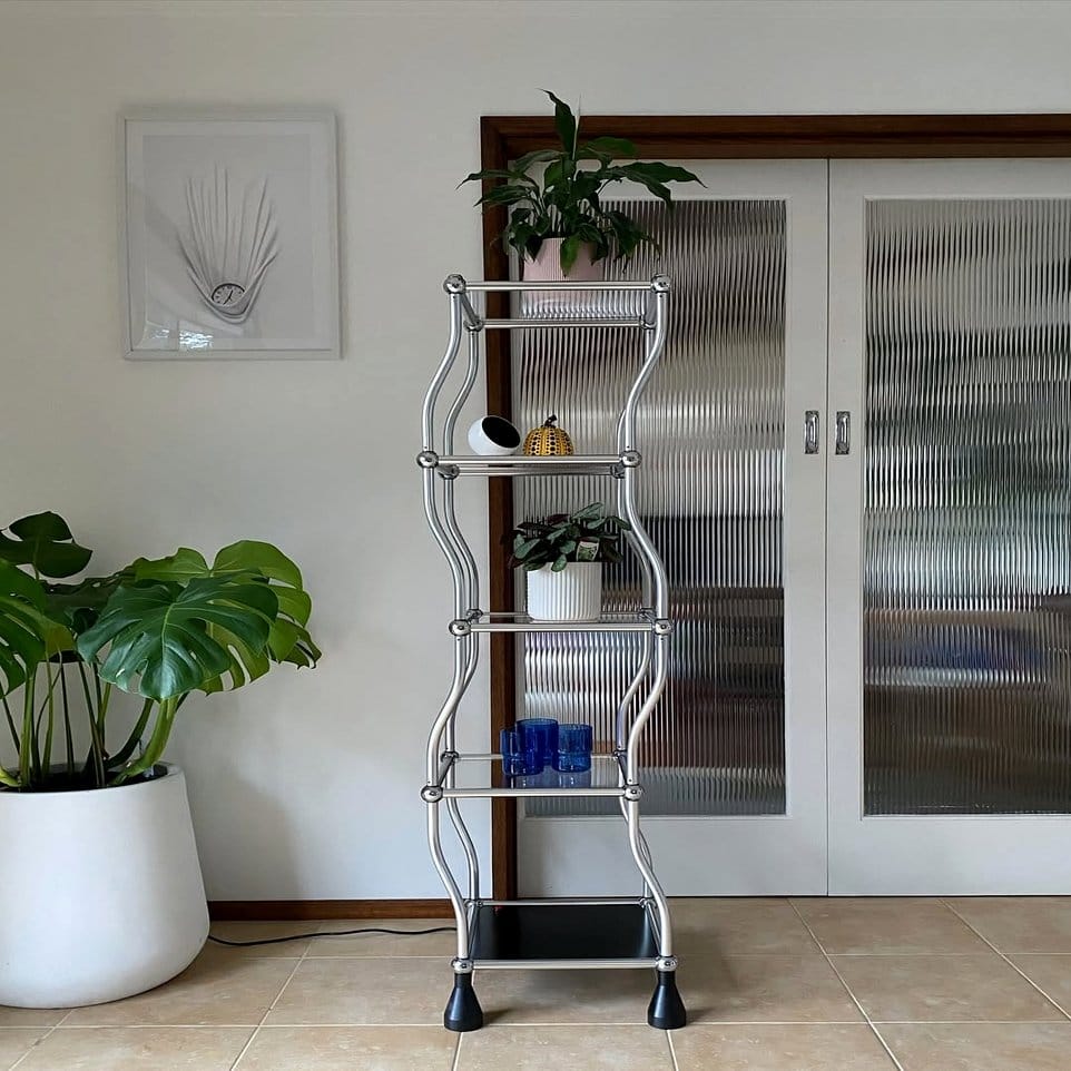 Paired chrome plant shelves with contrasting plants