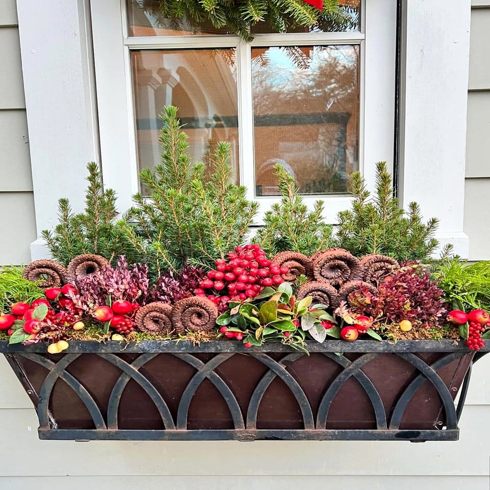 Window box filled with skulls and seasonal flowers