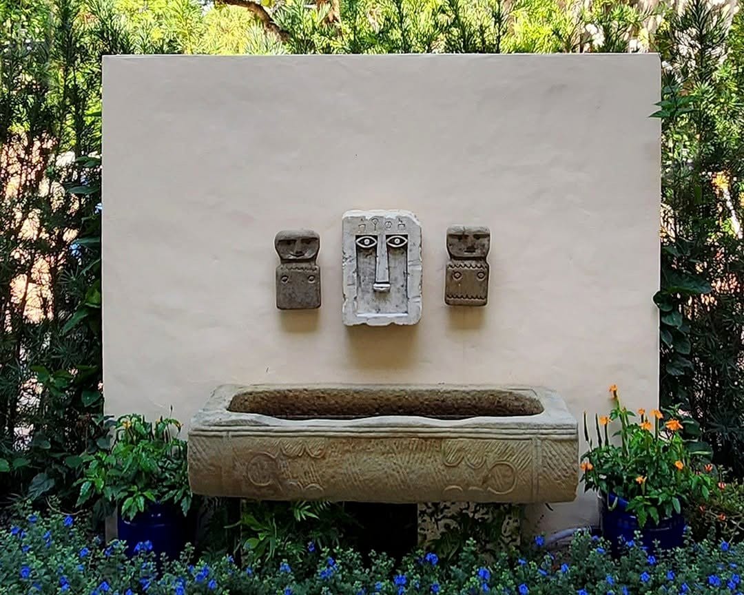 Stone water feature with Mayan carvings