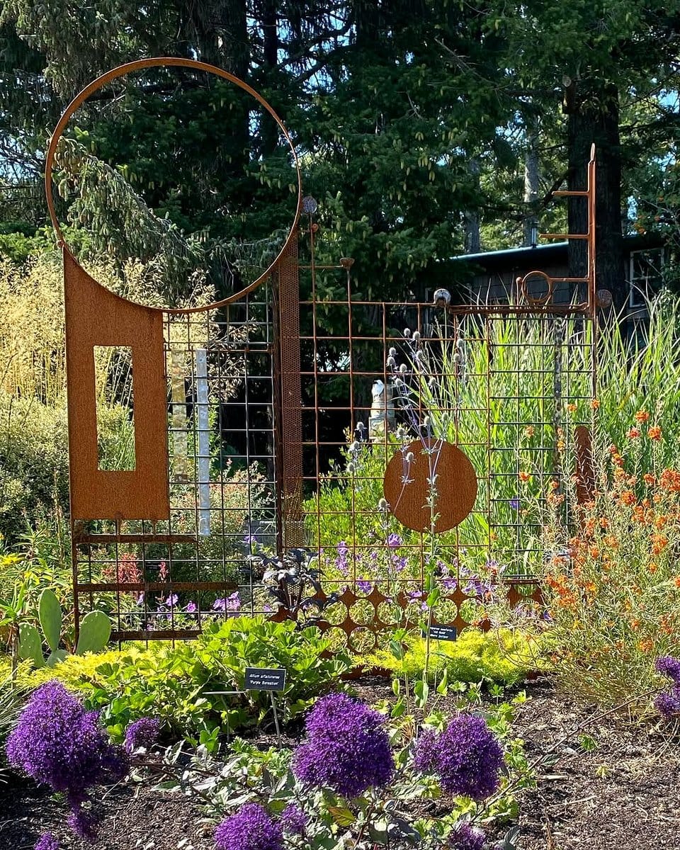 chalkboard stakes in flower bed