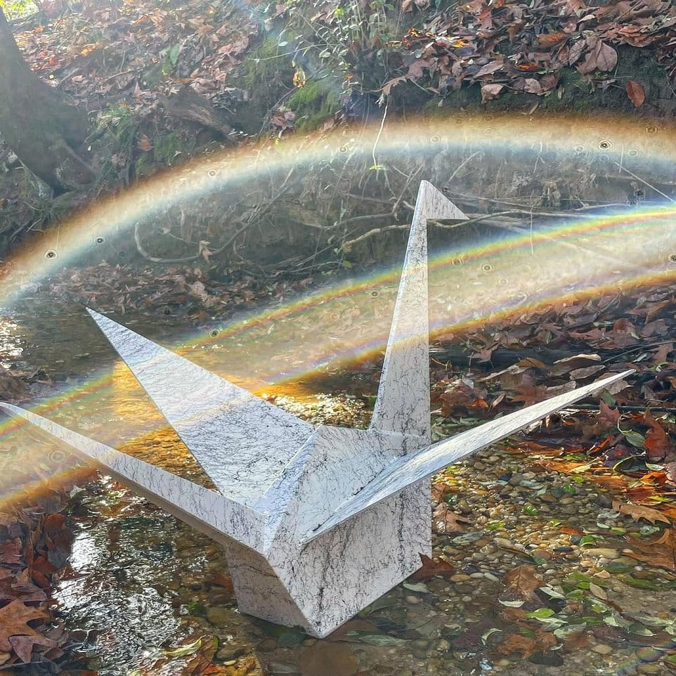 Shimmering metallic origami cranes with plants