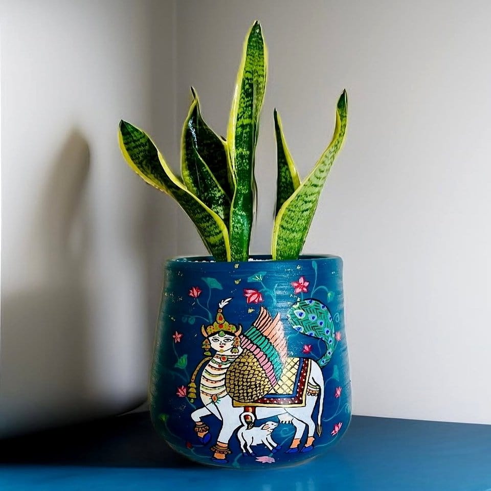 Celestial-themed painted plant pot with stars and moon