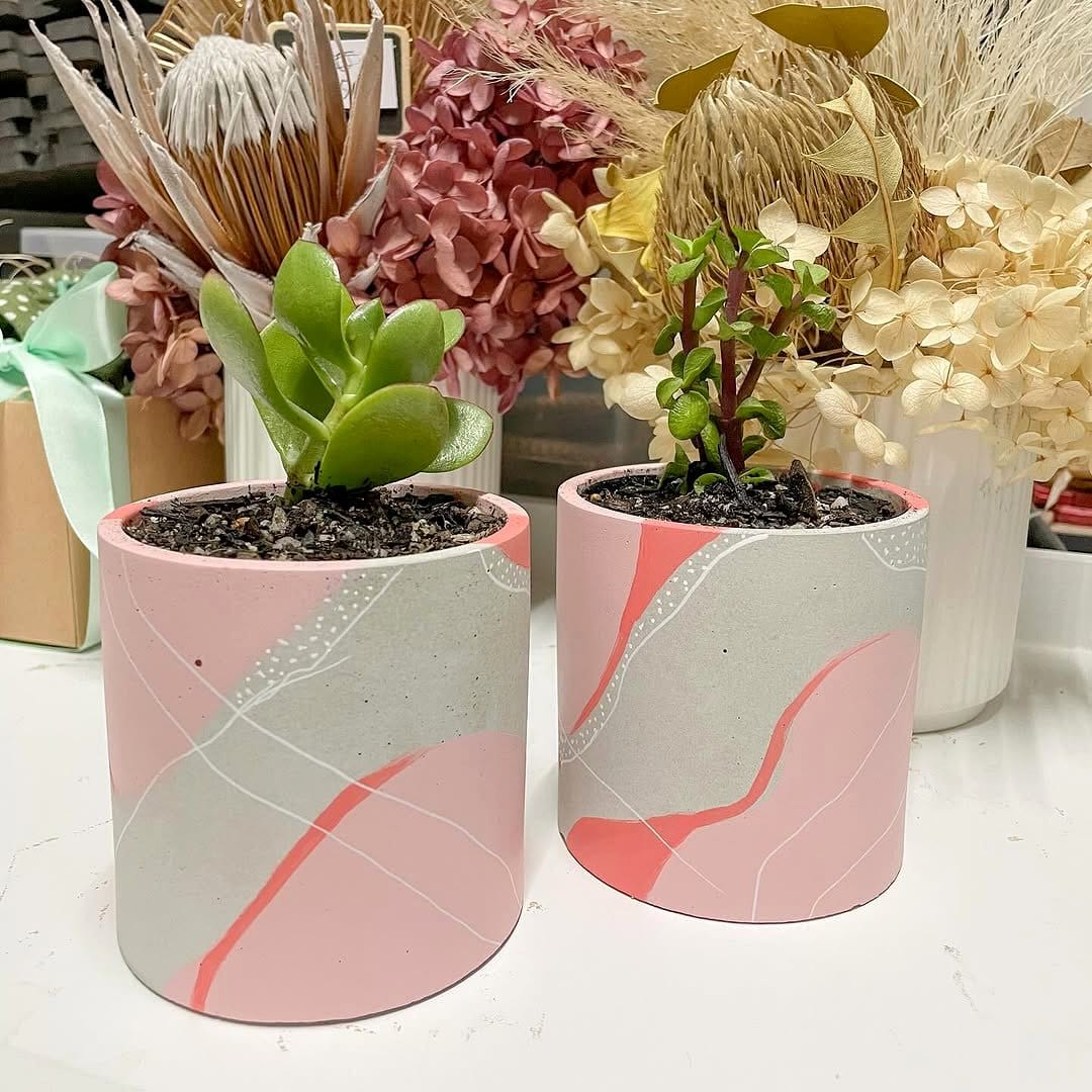 painted concrete planter with plants