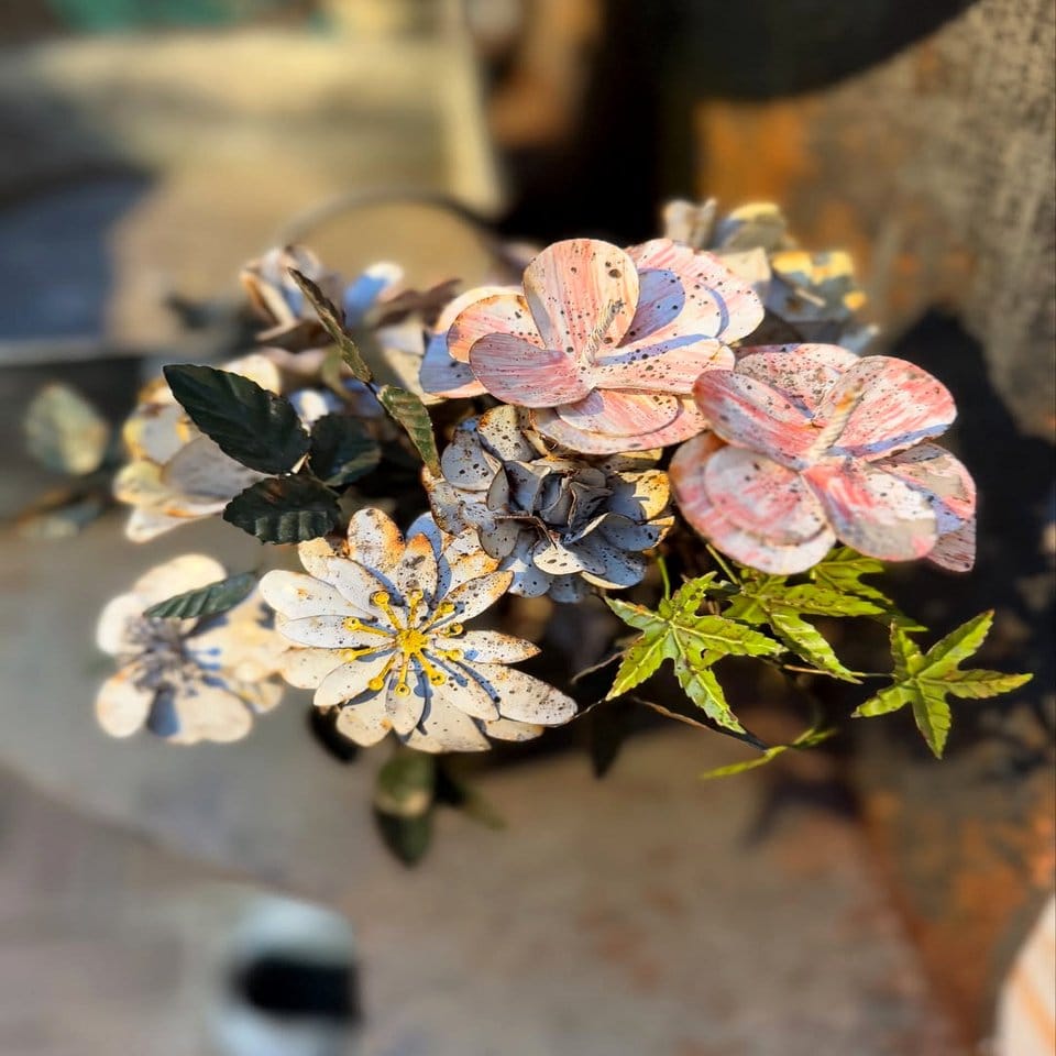 Vintage metal bucket with flowering plant