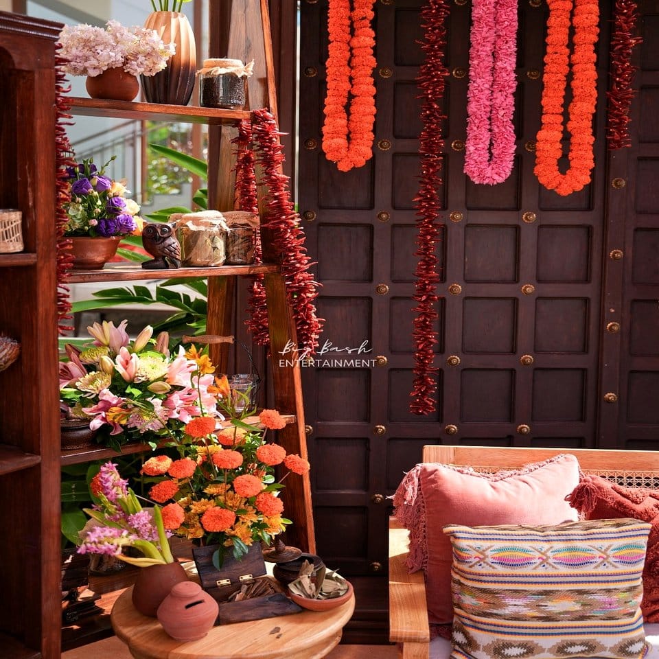 Layered tapestry backdrop with plant arrangement