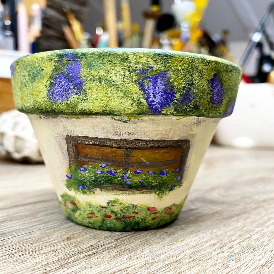 Fairy tale-themed painted plant pot with castle