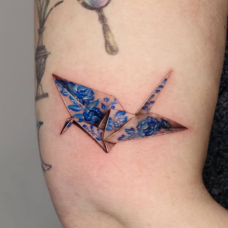 Origami cranes with twigs and leaves