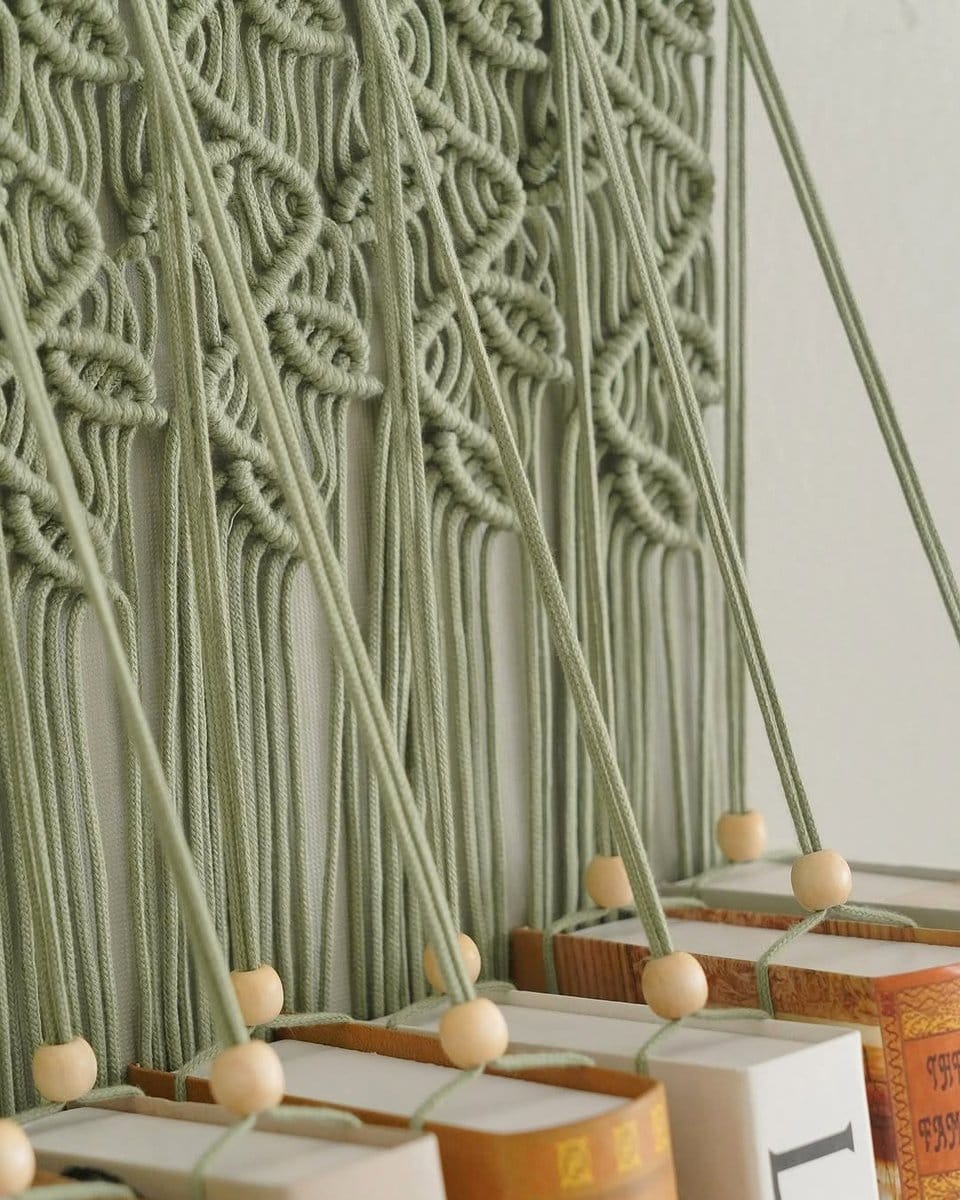 bookshelf with leafy decor and books