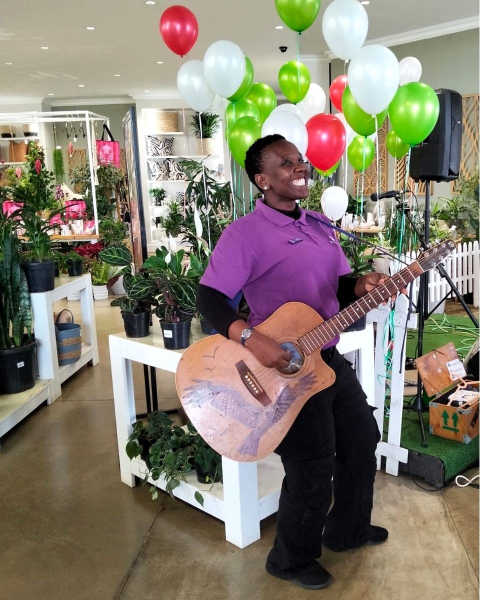 person photographing guitar planter