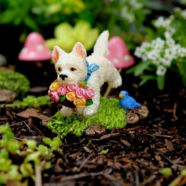 Fairy garden setup on wrought iron plant stand