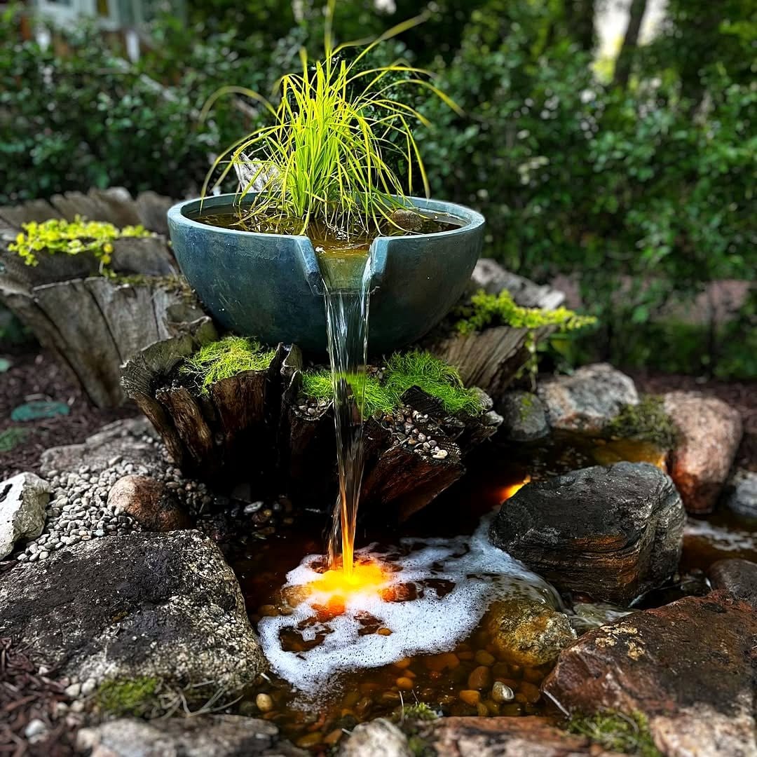 moss-covered fountain with small plants