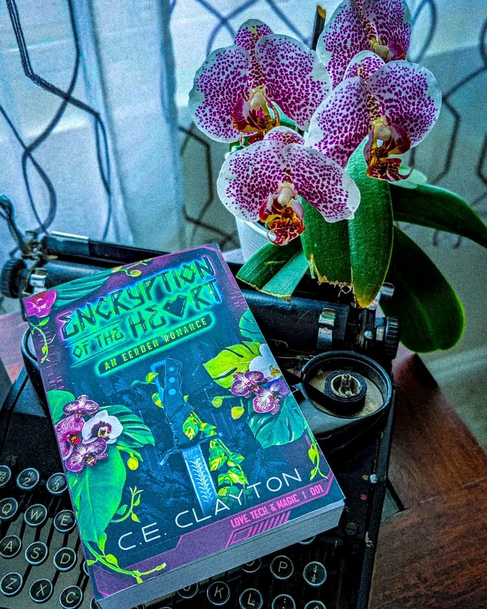 typewriter with orchids on bookshelf