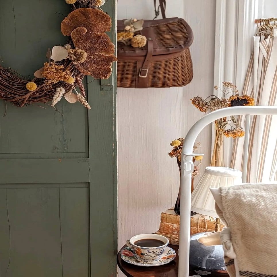 Rattan shelf with vintage teacups and small plants