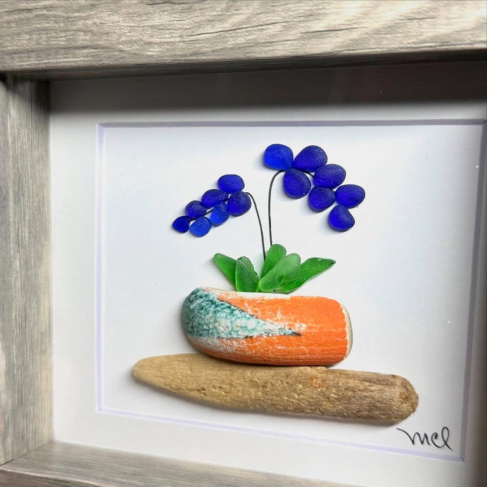 Sea glass mosaic planter with vibrant flowers