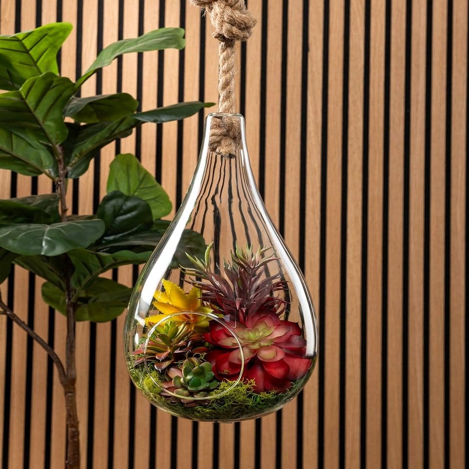 Hanging raindrop glass terrarium with tropical plants