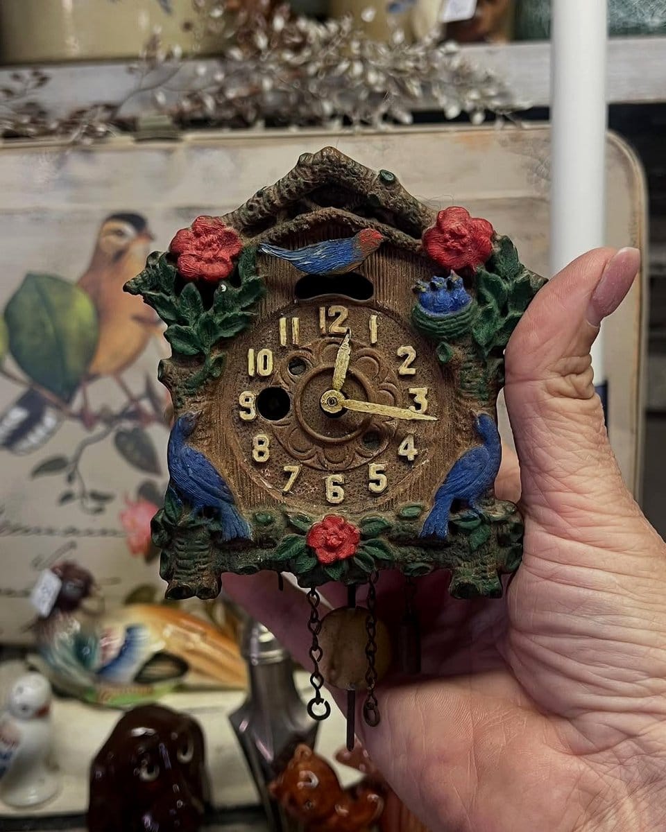 miniature figurines in birdcage