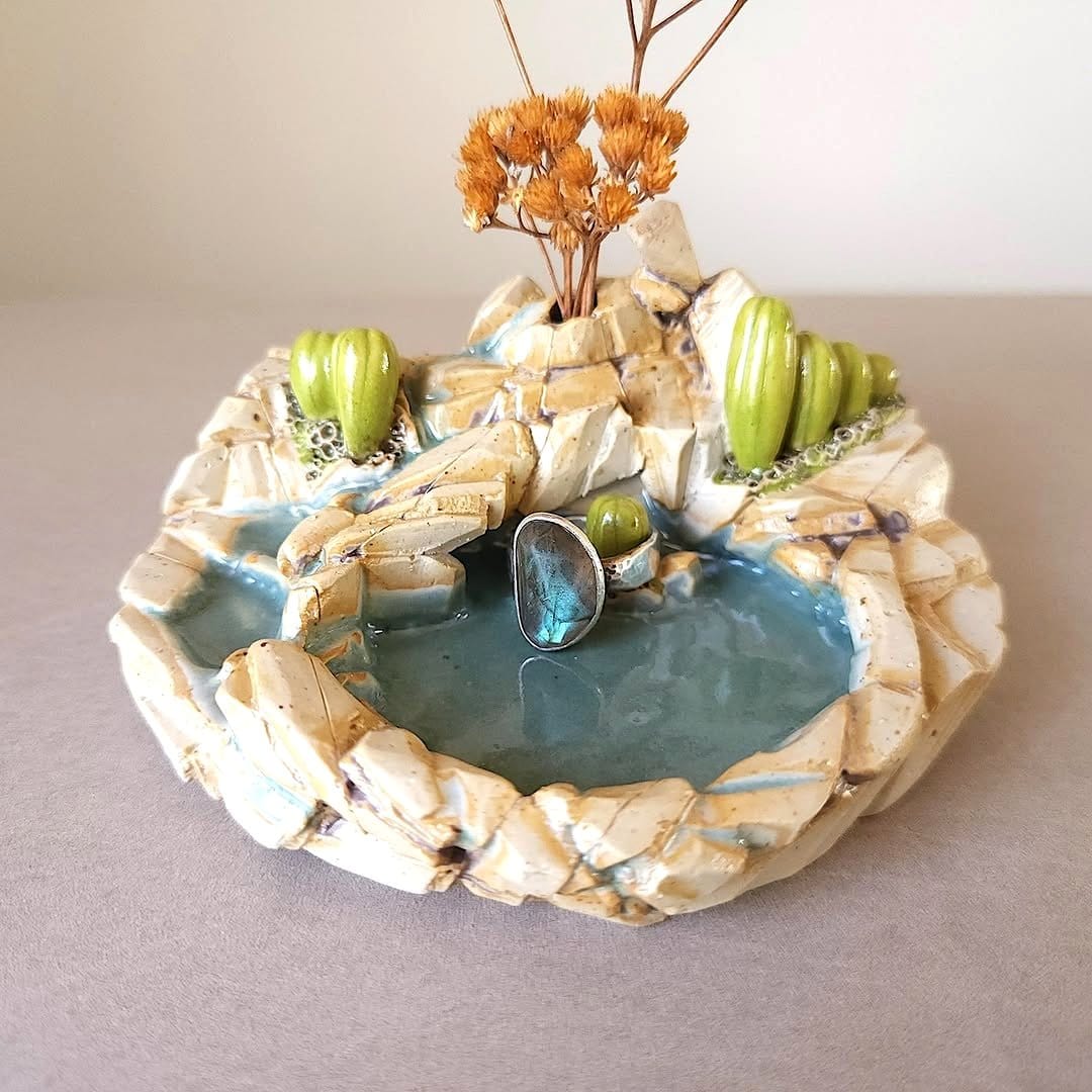 Glass terrarium with cacti and sand