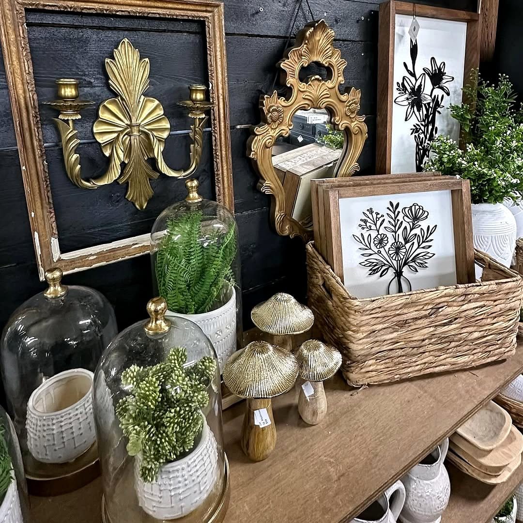 Rattan shelf with framed plant prints and live greenery