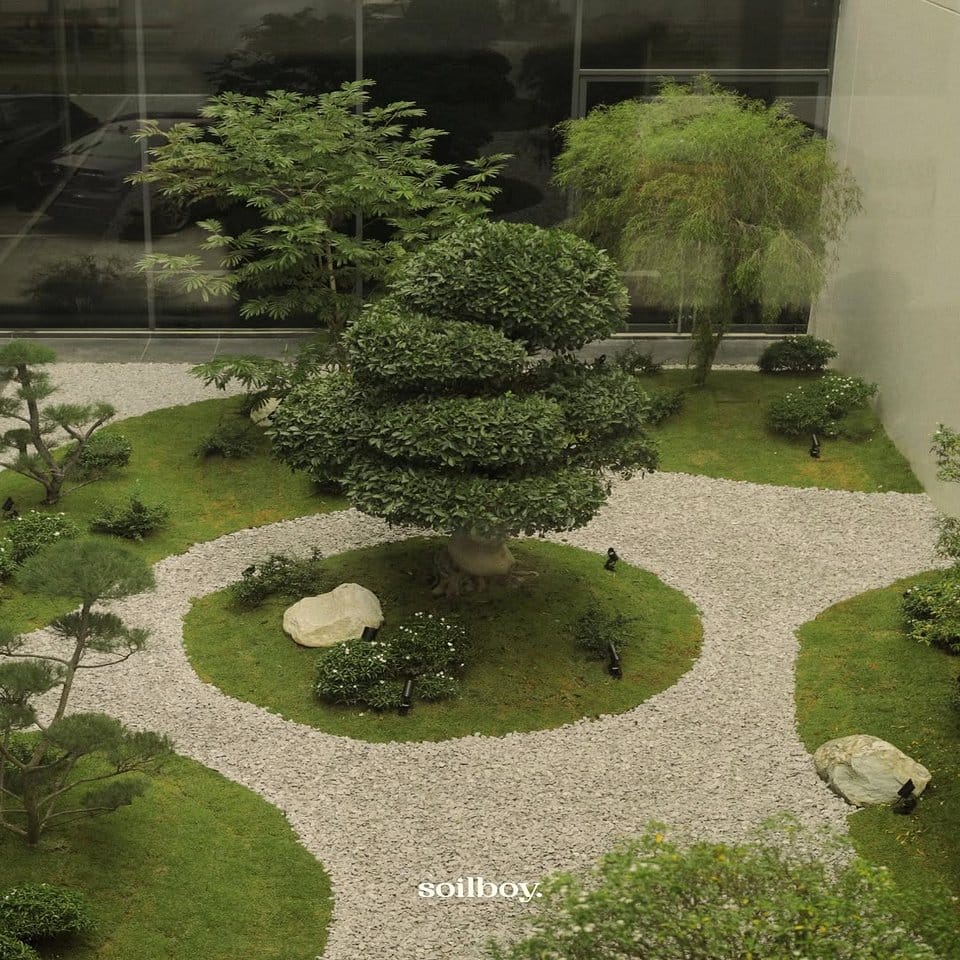 Zen garden-themed wrought iron stand with bonsai