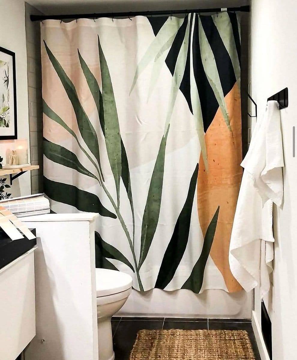 leafy shower curtain in bathroom