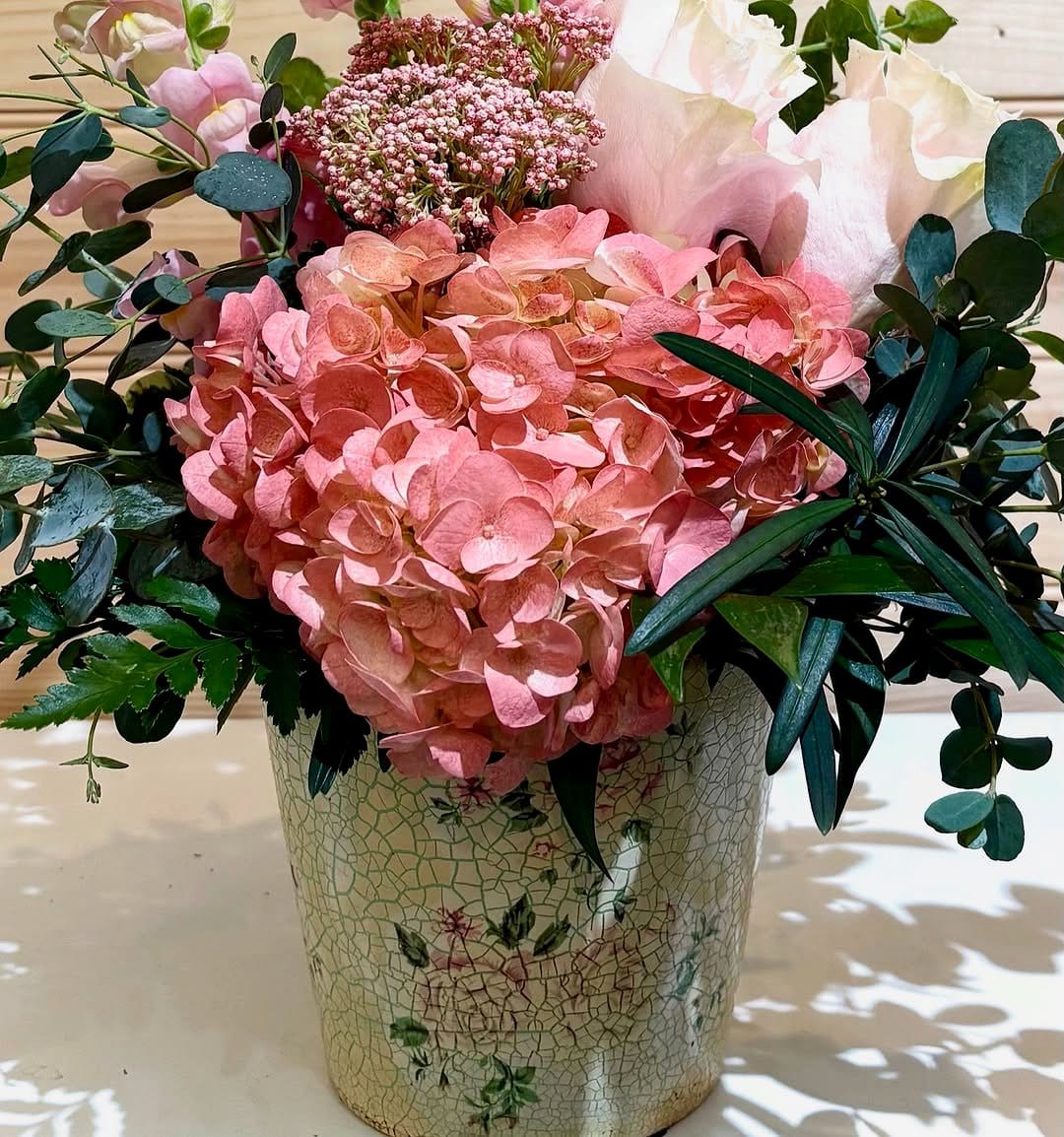 Overflowing flowers in a vintage can