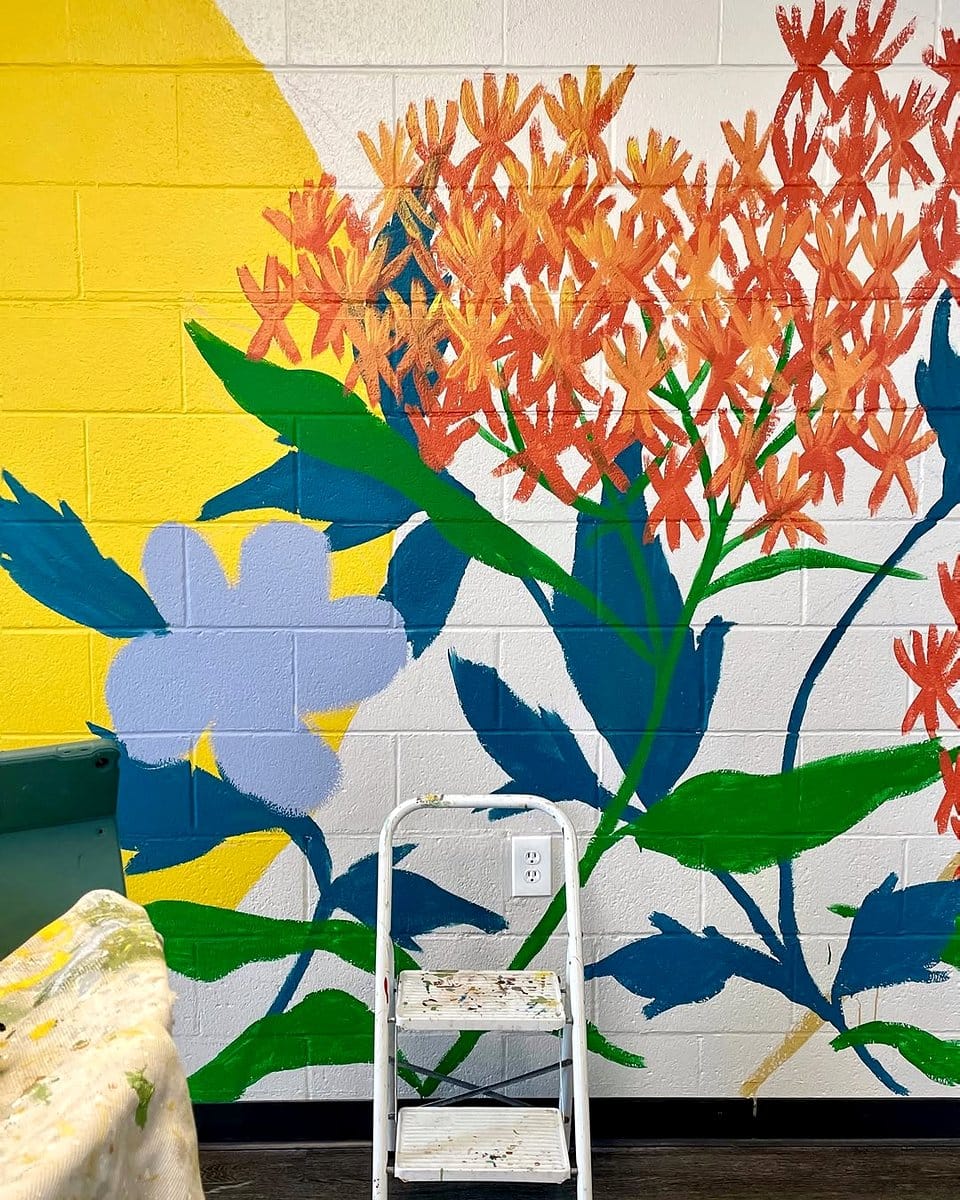 large colorful leaf mural on wall