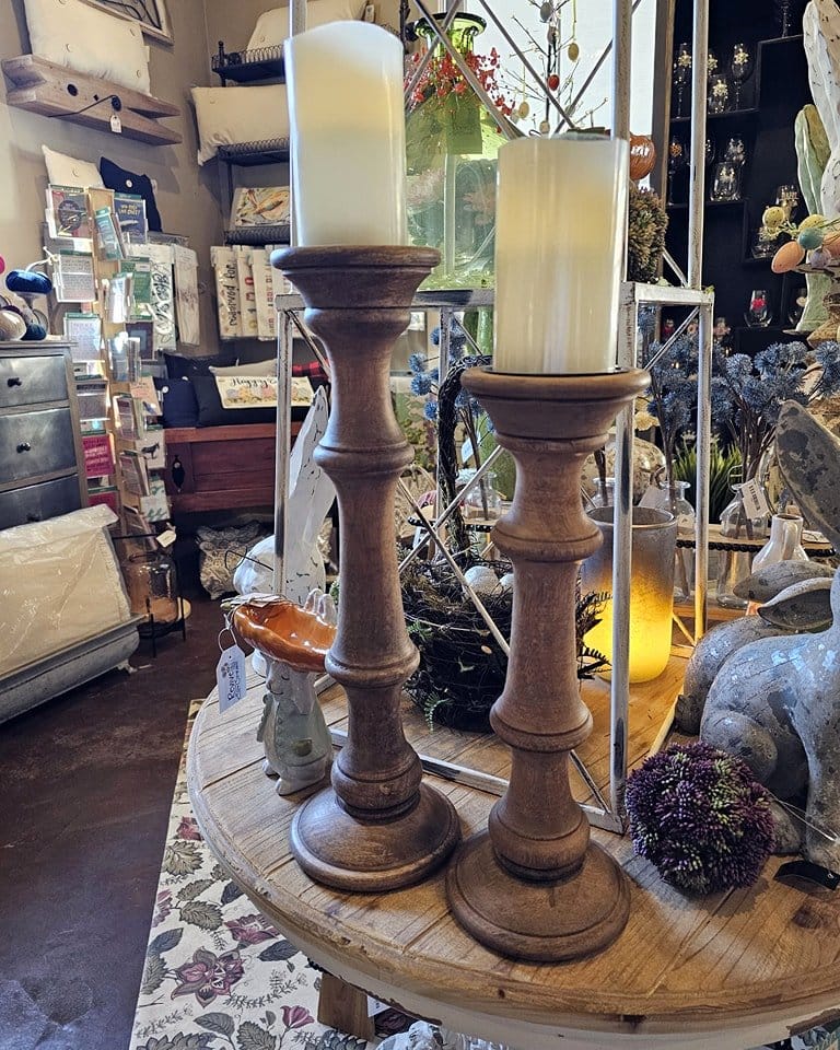 Rustic candle holders on wooden mantel