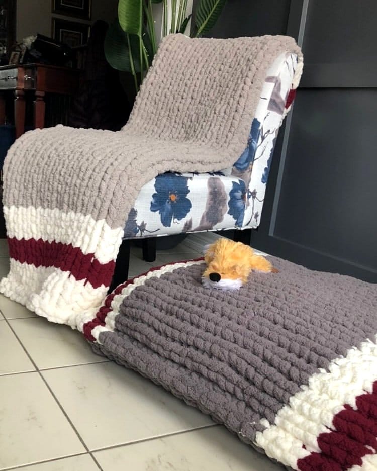 Comfortable armchair with knitted blanket