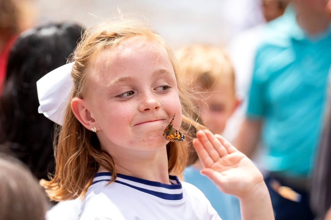child releasing butterfly