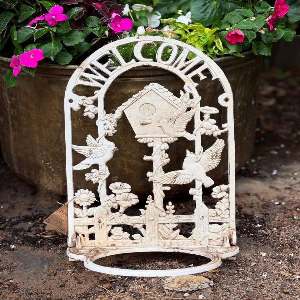 Birdhouses and plants on wrought iron stand