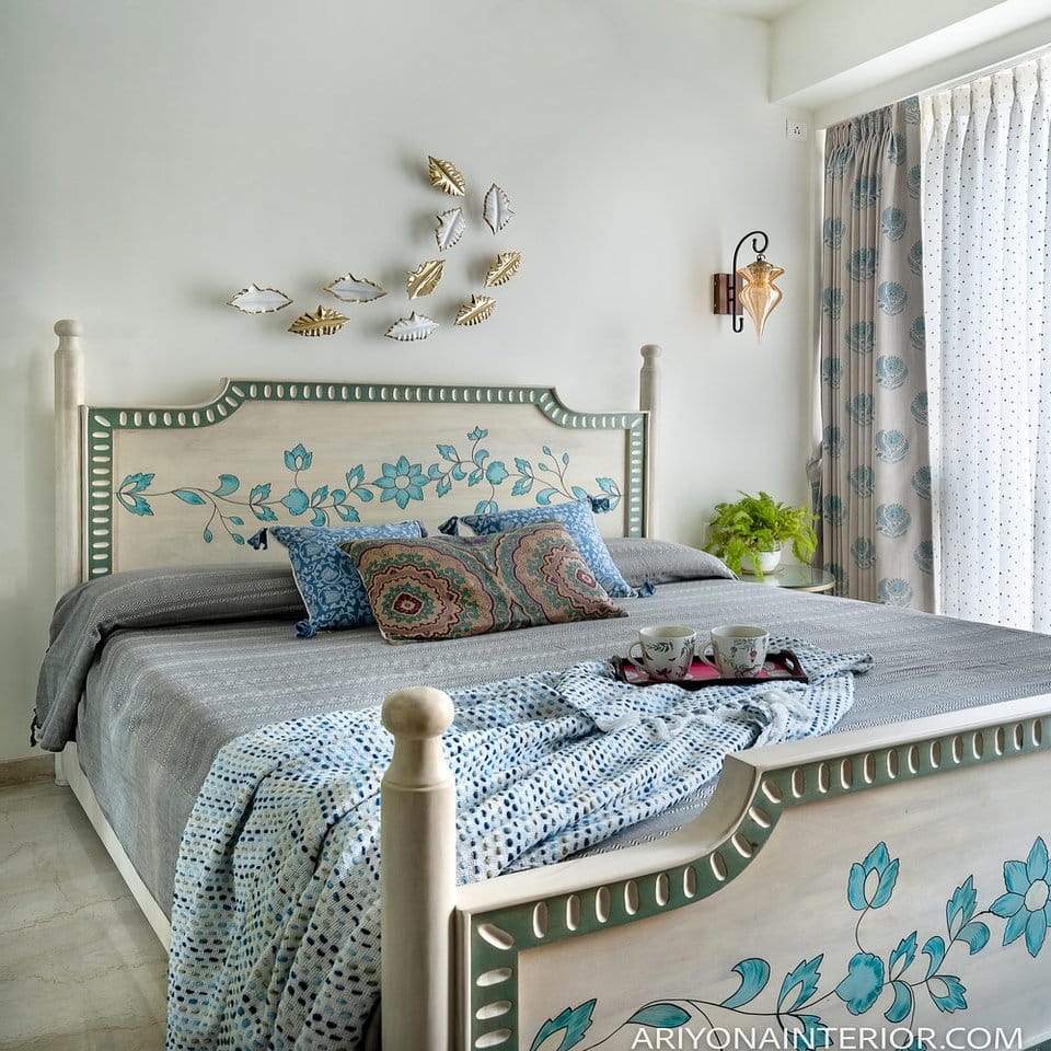 Romantic bedroom with glacier blue ice plant arrangement on a nightstand