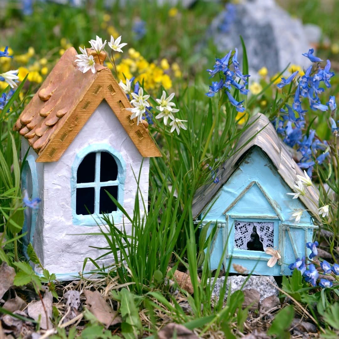 Birdhouse decorated with alpine wildflowers
