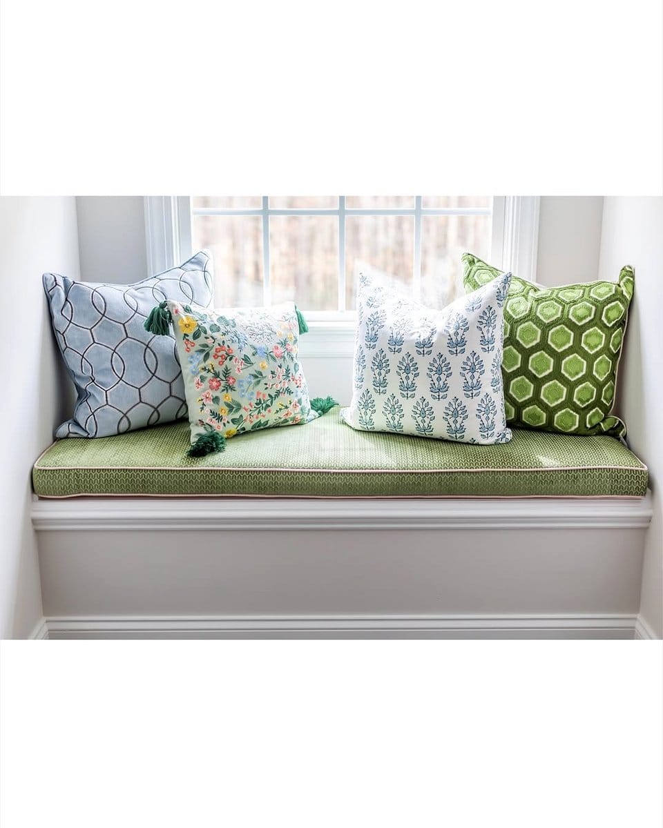 Cozy window seat with colorful cushions