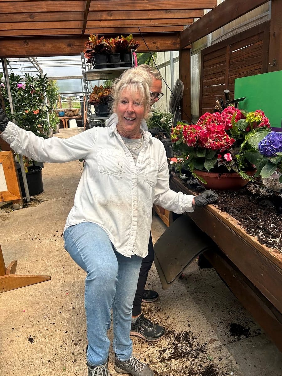 Outdoor patio with petrified wood slice plant stand and vibrant flowers