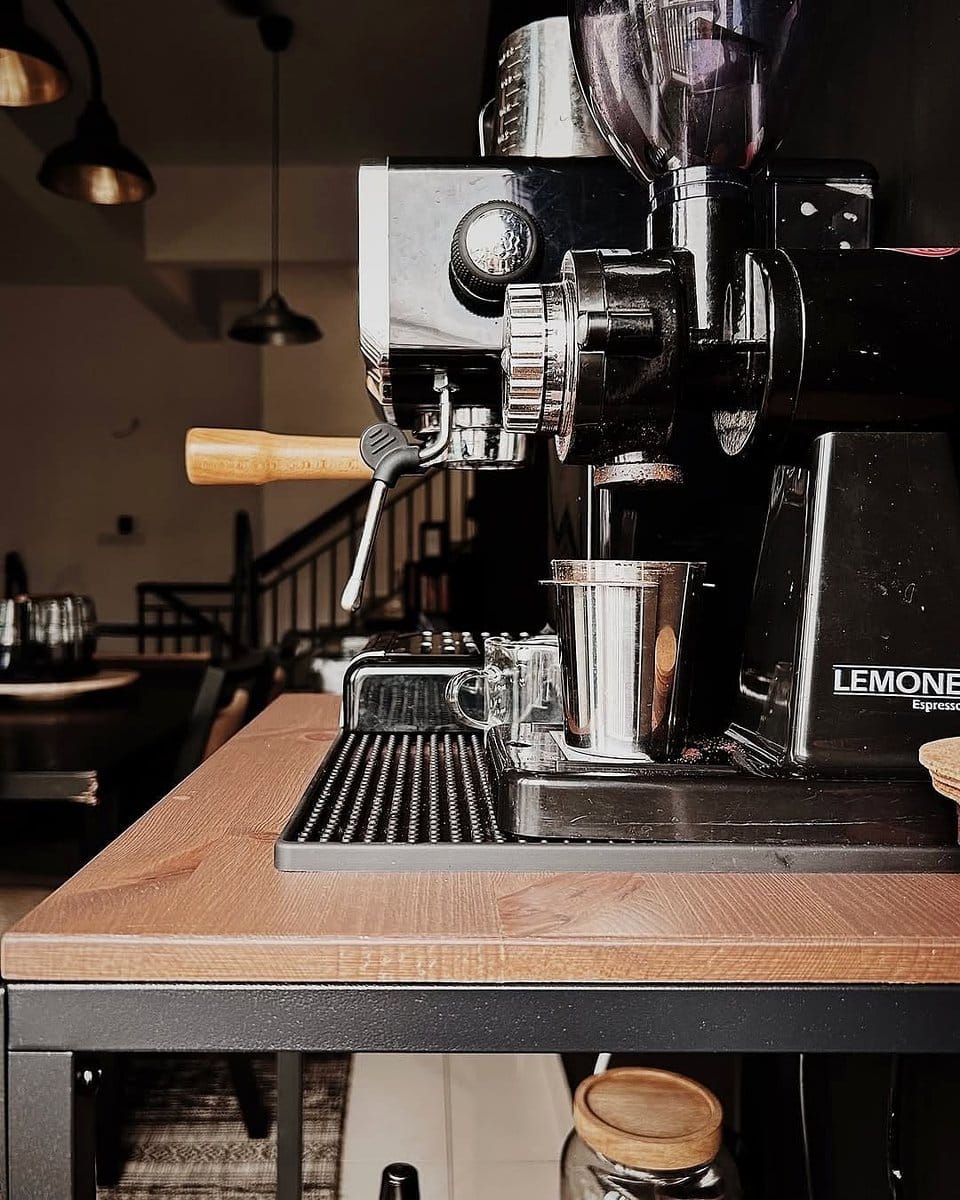 Rustic coffee station with wooden shelves and mugs