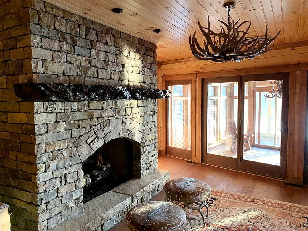Rustic stone fireplace with wooden mantel