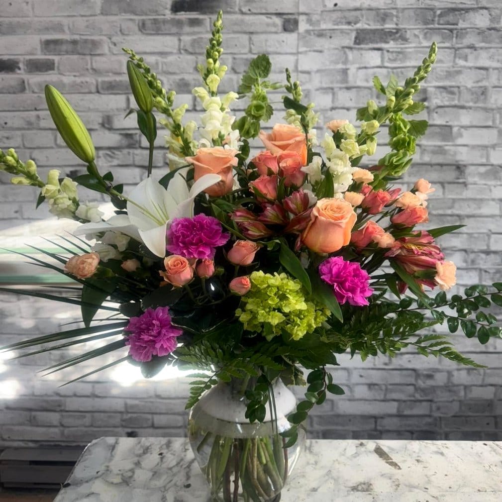 Mixed flowers in a tall vase