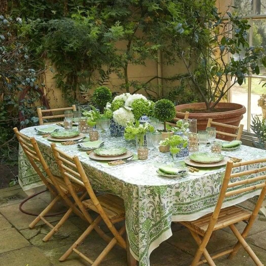 Outdoor dining area with jade plants and a rustic table