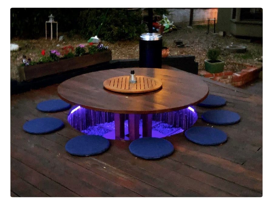 elevated cable spool table with tall plants