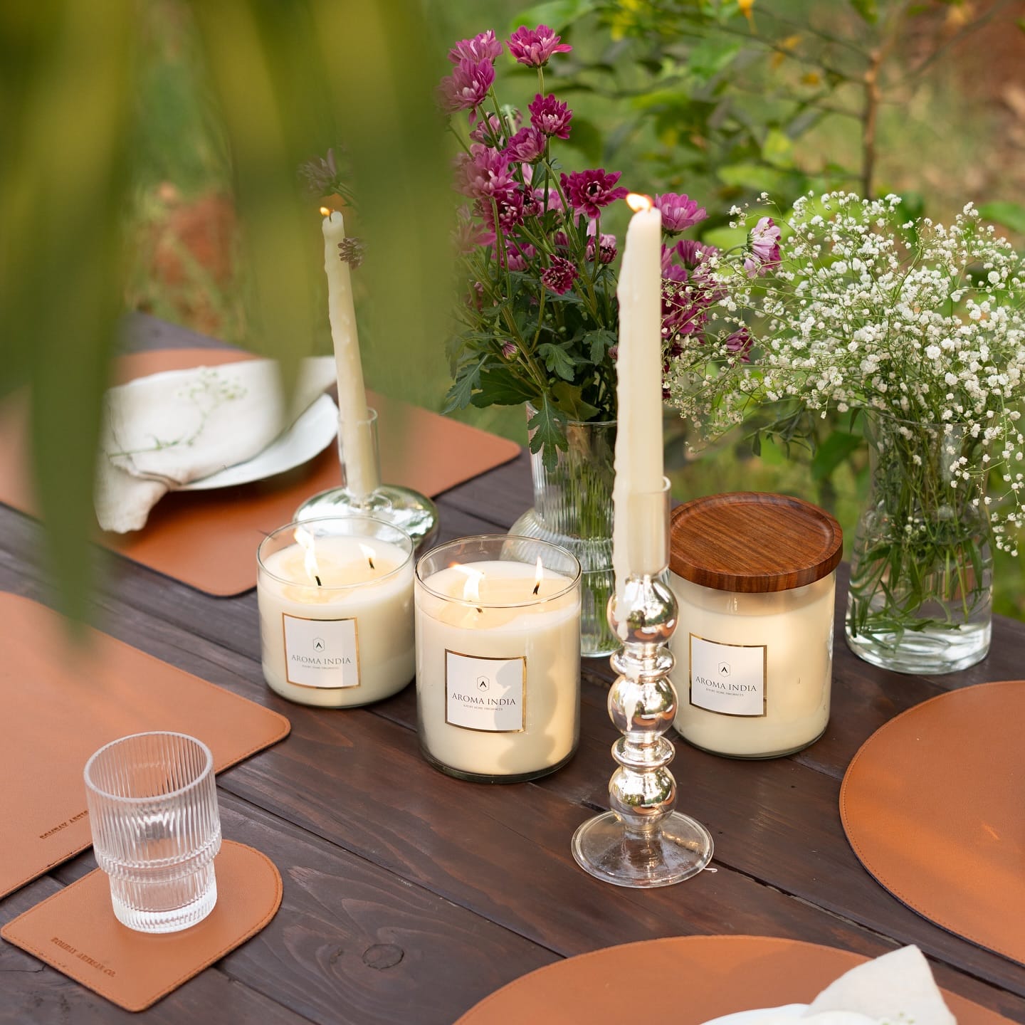 scented candles beside potted plants