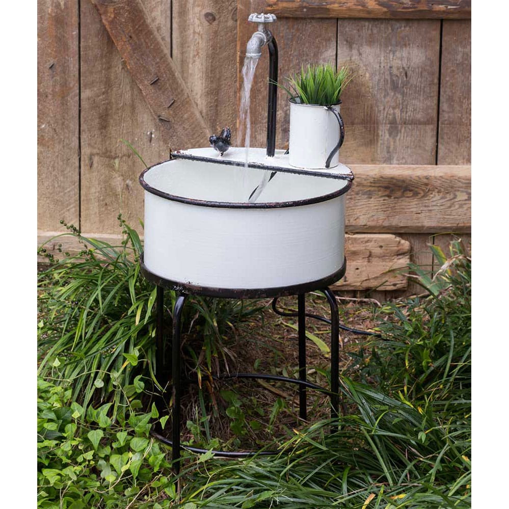 antique butler sink with mixed greenery